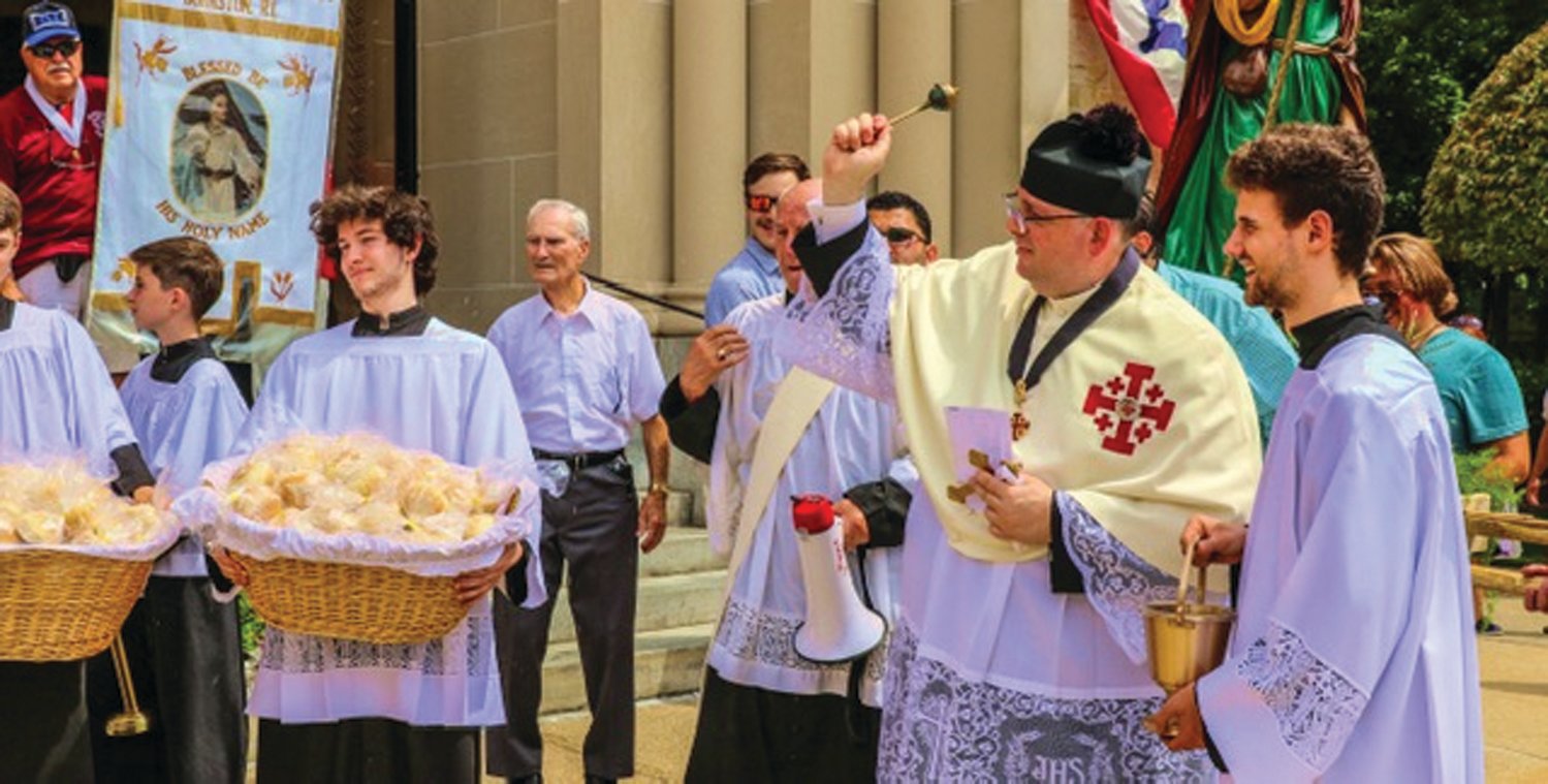 BLESSED CRUST: Participants watch the traditional Blessing of The Bread at St. Rocco’s Feast and Festival.